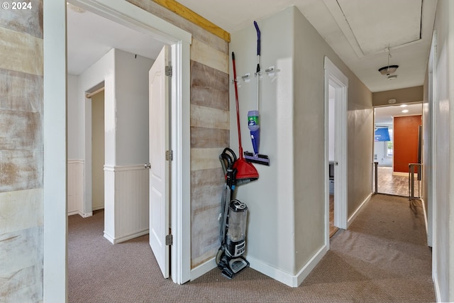 corridor featuring light colored carpet