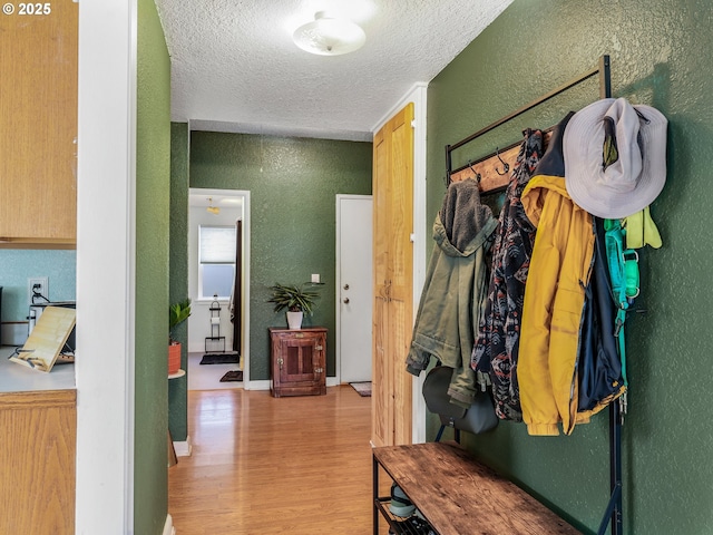740 Florence Ave, Astoria, OR 97103 - mudroom with a textured wall, a textured ceiling, and wood finished floors