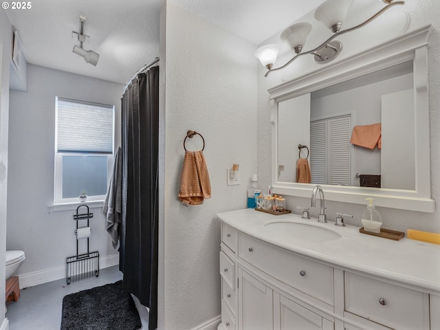 740 Florence Ave, Astoria, OR 97103 - bathroom with toilet, vanity, baseboards, curtained shower, and a textured wall
