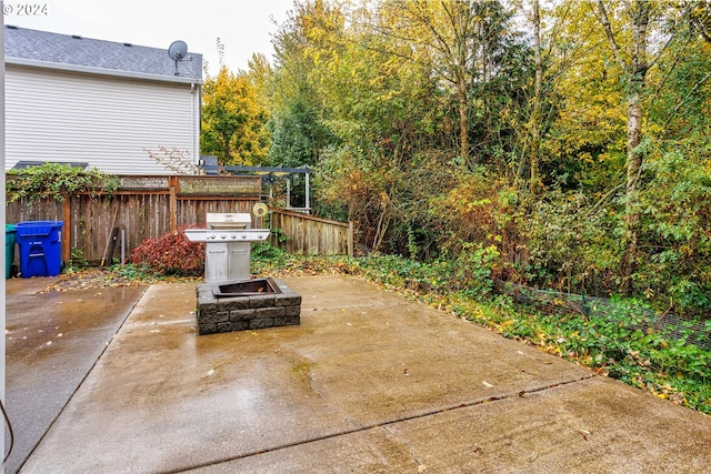 view of patio featuring area for grilling and a fire pit