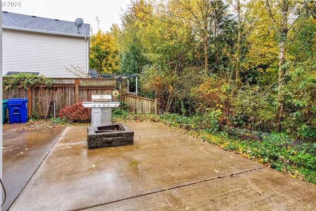 1018 NE Mariners Loop, Portland, OR 97211 - view of patio / terrace with a fire pit, fence, and area for grilling