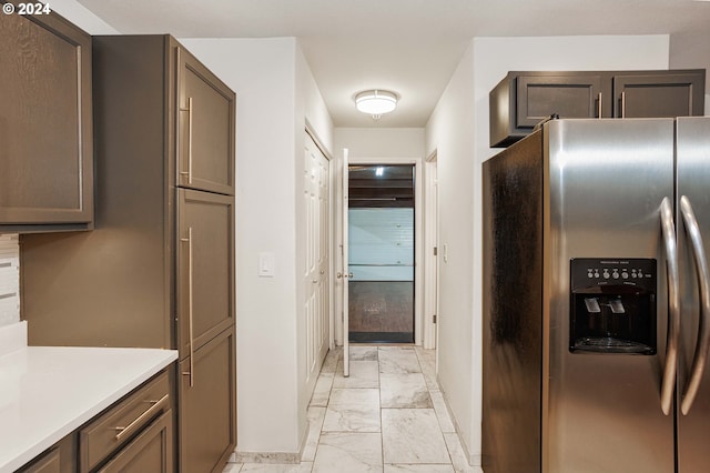 kitchen with dark brown cabinetry and stainless steel fridge with ice dispenser