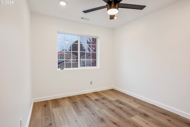 empty room featuring ceiling fan and light hardwood / wood-style flooring