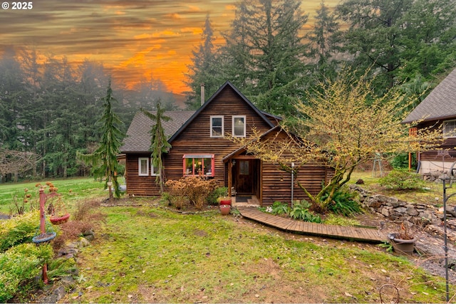 log cabin featuring a lawn