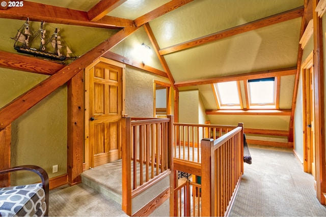 additional living space with carpet floors and vaulted ceiling with skylight