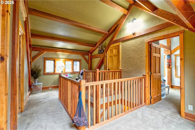 corridor featuring vaulted ceiling with beams and light colored carpet