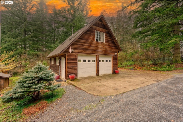 view of garage at dusk