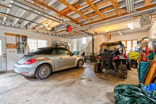 garage featuring electric panel and a garage door opener