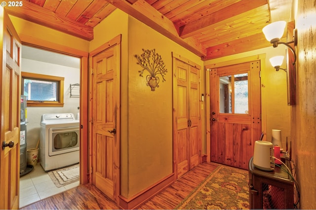 tiled foyer featuring wooden ceiling, beamed ceiling, washer / dryer, and water heater