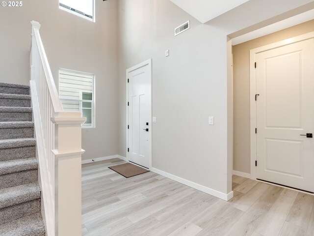 carpeted bedroom with multiple windows, crown molding, and ceiling fan