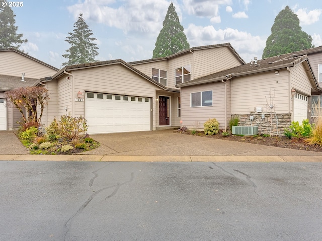 front of property featuring a garage and central air condition unit