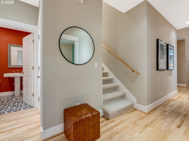 stairs with hardwood / wood-style floors