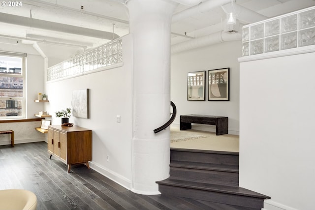 staircase featuring baseboards and wood finished floors