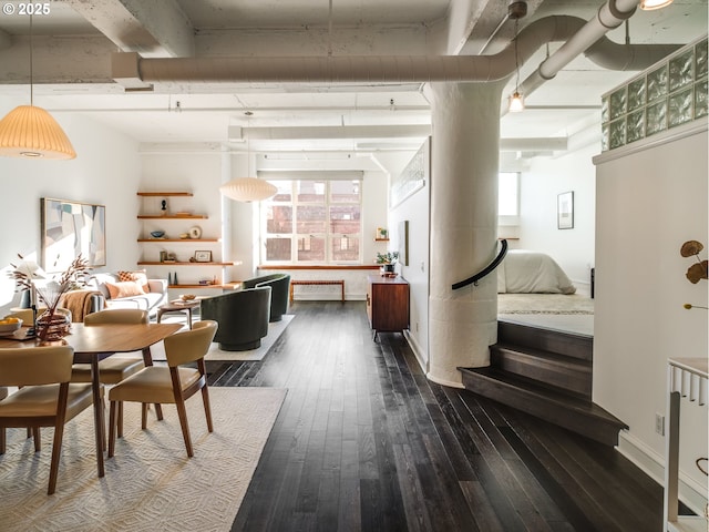 dining area featuring dark wood-type flooring, plenty of natural light, and baseboards