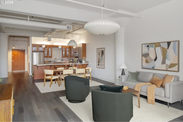 living room with sink and dark hardwood / wood-style flooring