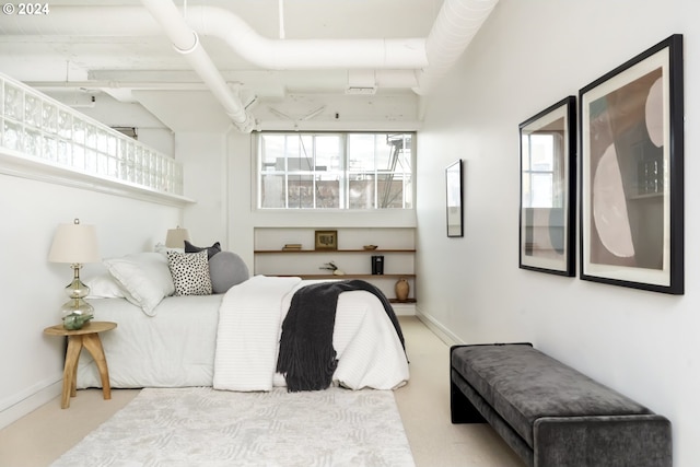 bedroom with multiple windows and light colored carpet