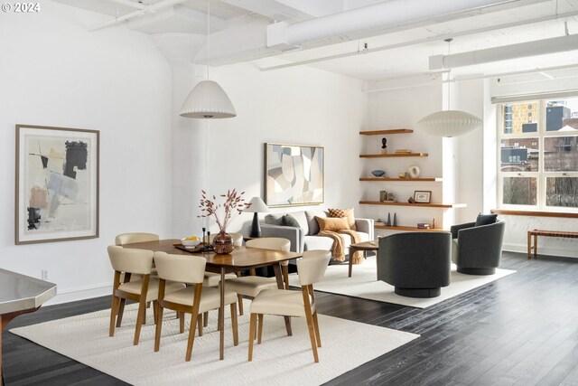 kitchen featuring appliances with stainless steel finishes, a towering ceiling, kitchen peninsula, decorative backsplash, and dark wood-type flooring