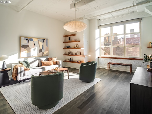 living area featuring dark wood finished floors and baseboards