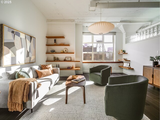 living area featuring a high ceiling and hardwood / wood-style floors