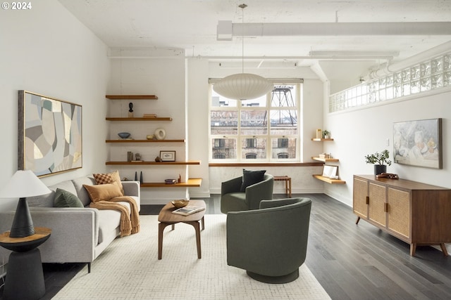 living area featuring baseboards and wood finished floors