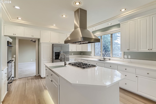 kitchen with island range hood, an island with sink, appliances with stainless steel finishes, and sink