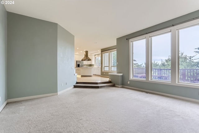 unfurnished living room featuring carpet flooring