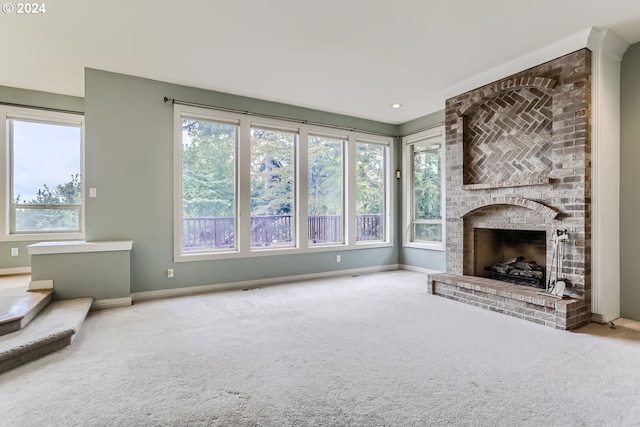 unfurnished living room with a brick fireplace and carpet flooring