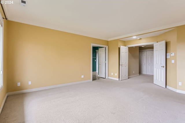 unfurnished bedroom with light colored carpet