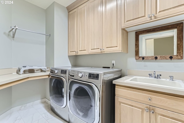 laundry room featuring washer and dryer, cabinets, and sink