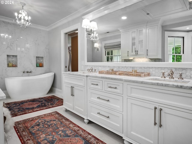 bathroom with vanity, crown molding, and a bathing tub