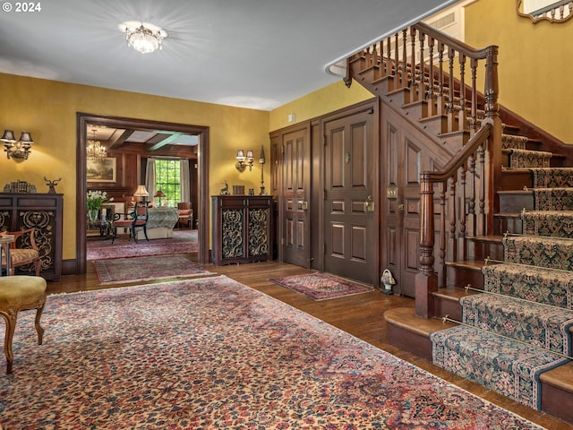 interior space with dark hardwood / wood-style flooring and a notable chandelier