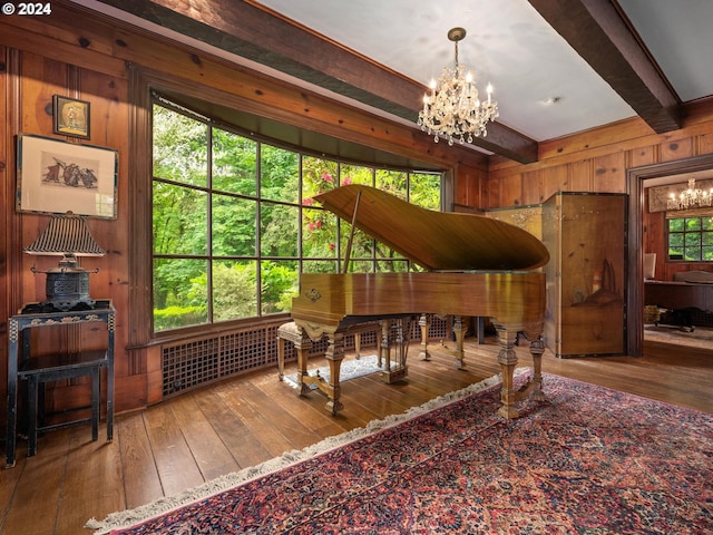 miscellaneous room with beam ceiling, wood walls, a chandelier, and wood-type flooring