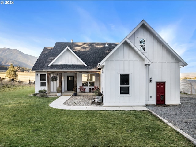 modern inspired farmhouse with a mountain view and a front yard