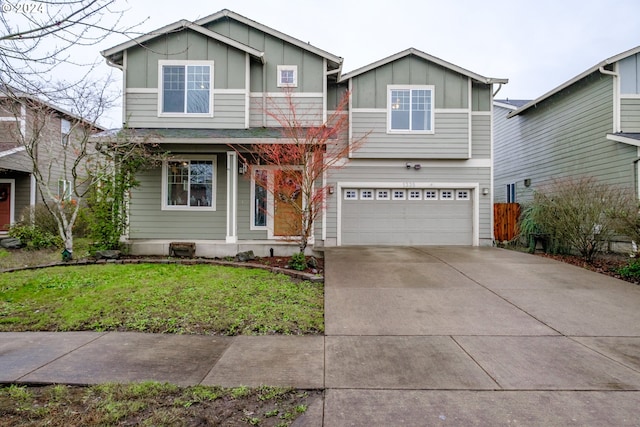 view of front of home featuring a garage and a front lawn