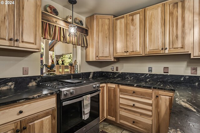 kitchen with pendant lighting, light brown cabinets, stainless steel appliances, dark stone countertops, and sink