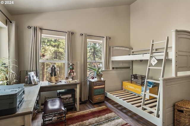 bedroom with dark hardwood / wood-style floors and lofted ceiling