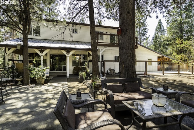 back of house featuring a patio and outdoor lounge area