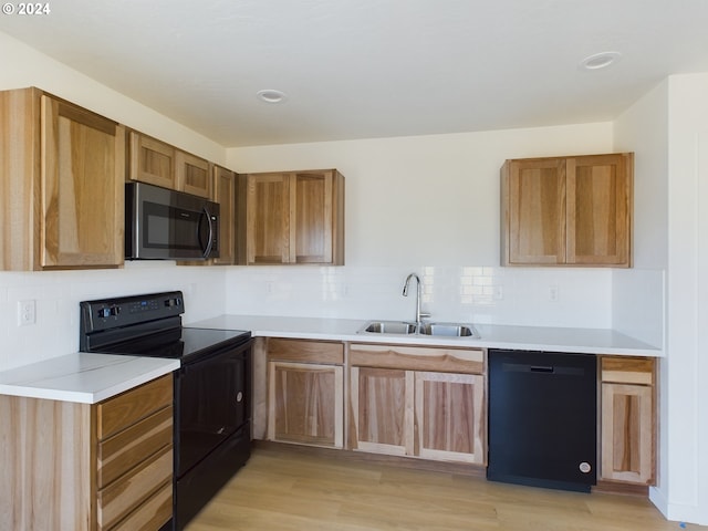 kitchen featuring stove, an inviting chandelier, an AC wall unit, light wood-type flooring, and black dishwasher