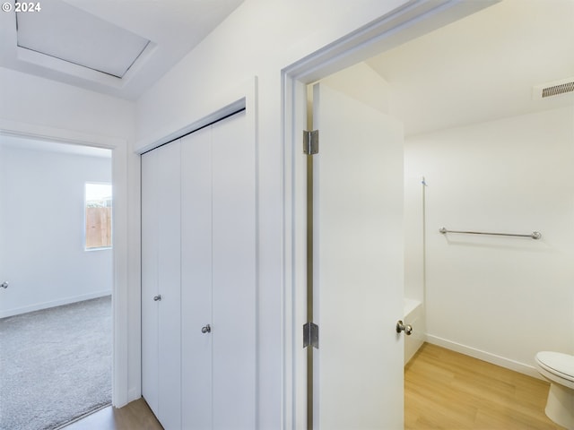 bathroom featuring wood-type flooring and toilet