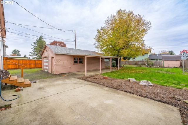 back of house with an outbuilding, a yard, and a patio area