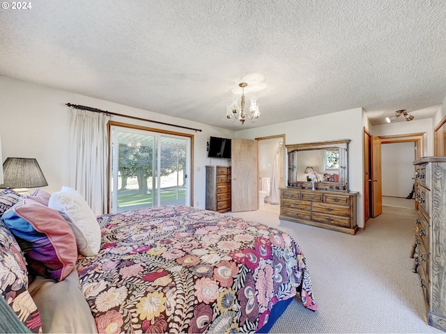 carpeted bedroom featuring access to outside, a textured ceiling, and a notable chandelier