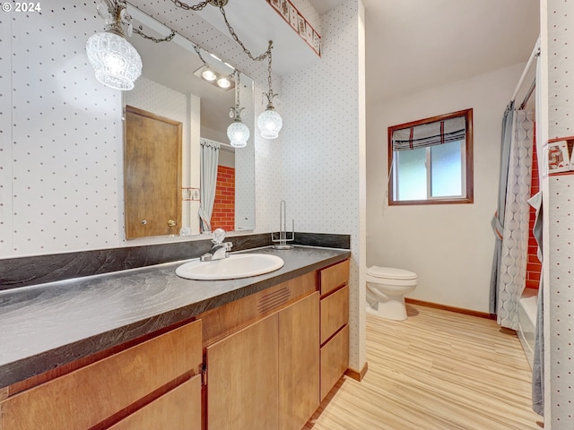 full bathroom featuring toilet, shower / bath combo, vanity, and wood-type flooring