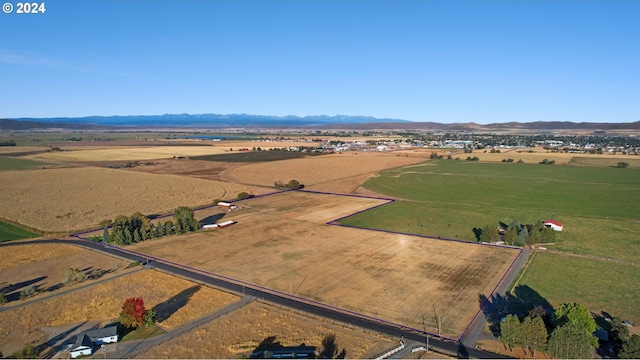 birds eye view of property featuring a mountain view and a rural view