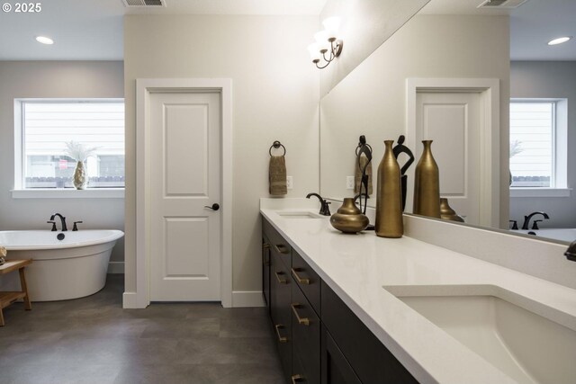 washroom with washer and dryer, cabinets, and sink