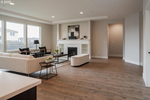 kitchen featuring a kitchen island with sink, sink, light wood-type flooring, light stone countertops, and appliances with stainless steel finishes