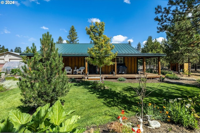 rear view of property with a yard