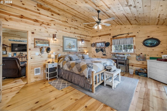 bedroom with vaulted ceiling, ceiling fan, wooden walls, light hardwood / wood-style flooring, and wooden ceiling