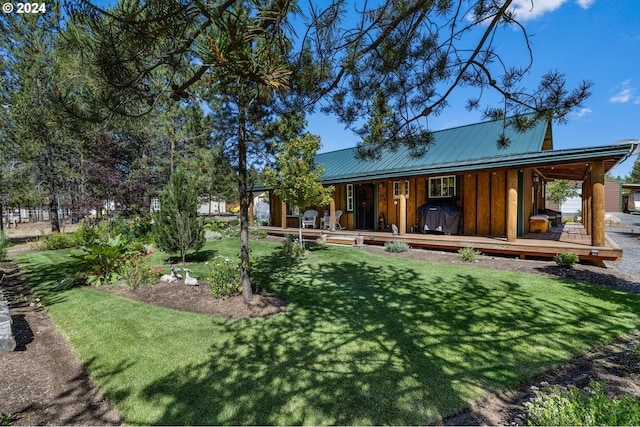 back of house with a lawn and covered porch