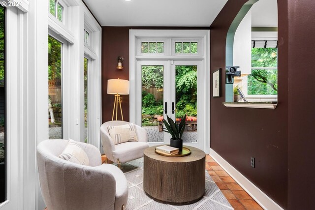 living area featuring french doors, tile patterned floors, and a wealth of natural light