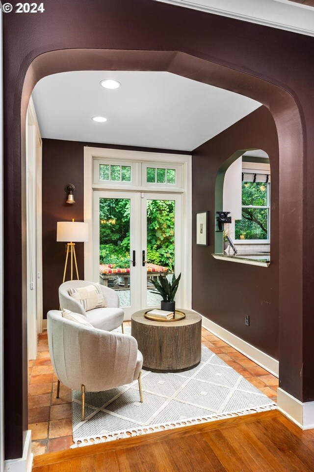 sitting room with light hardwood / wood-style flooring and french doors